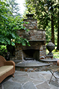 outdoor fireplace with bluestone hearth and flagstone patio